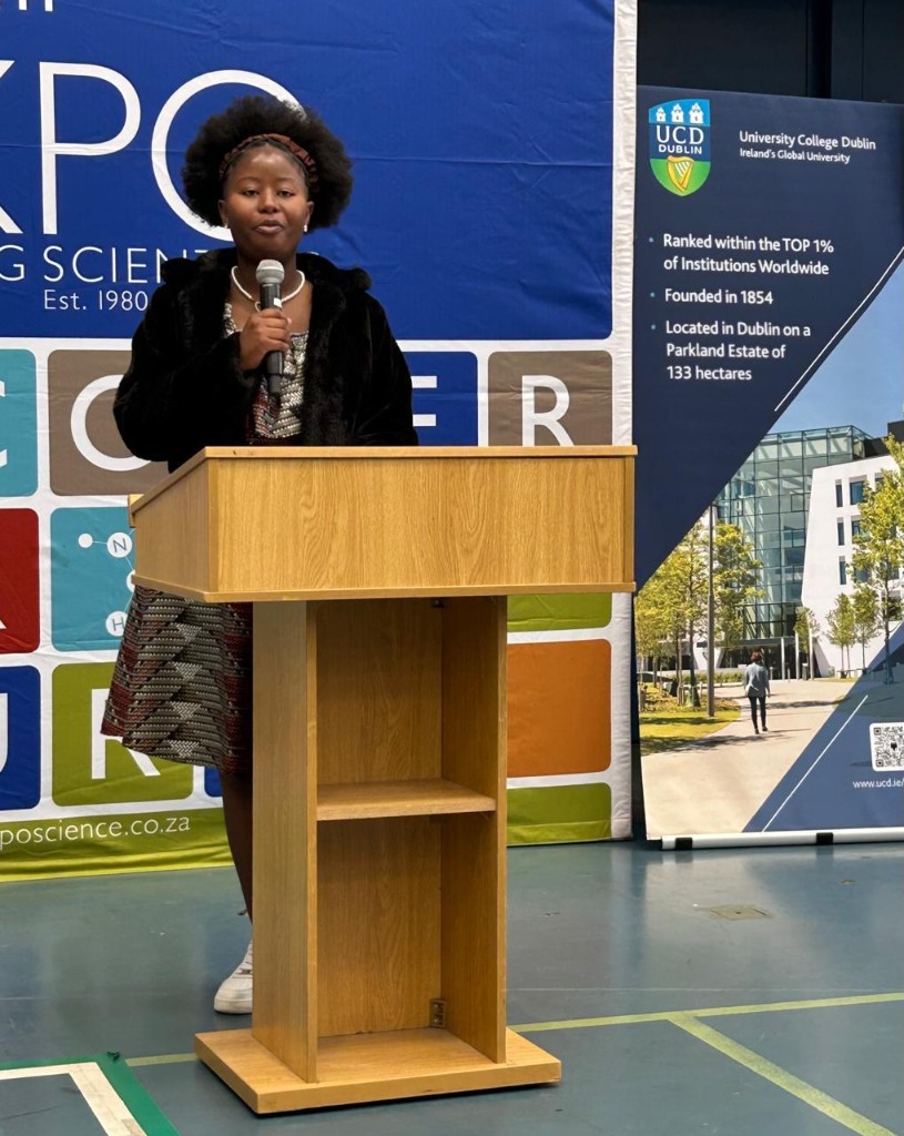 Diatile Ndhlovu speaking at a podium at an Eskom Expo for Young Scientists event